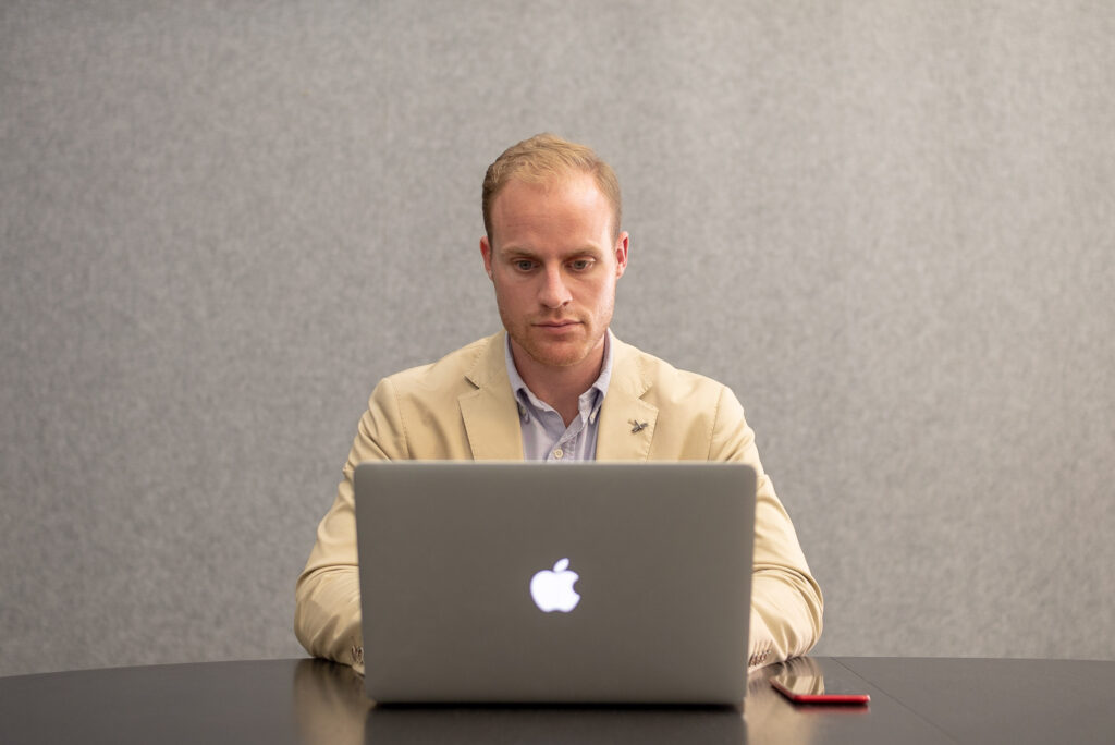 Joe Shew working at a laptop