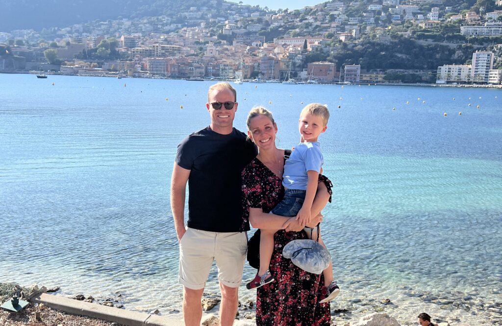 A family standing at a harbour overlook