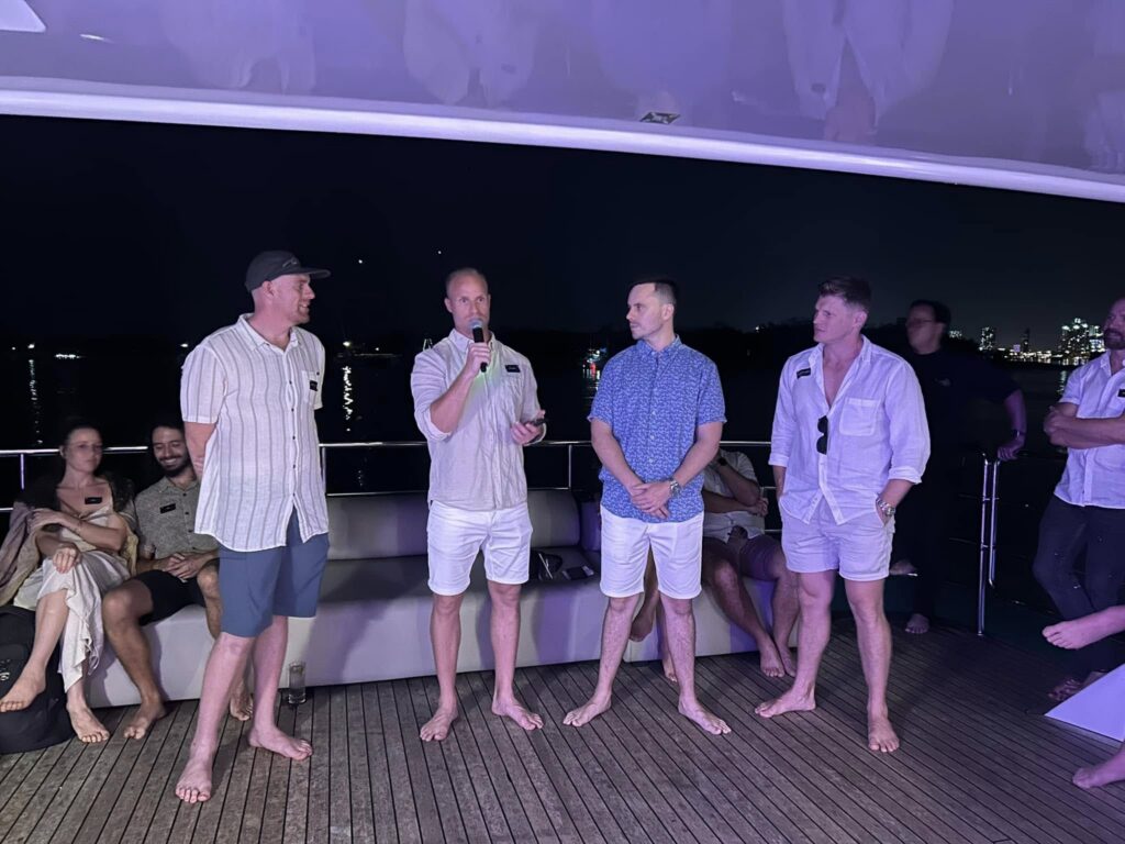 A group standing on a boat deck at night