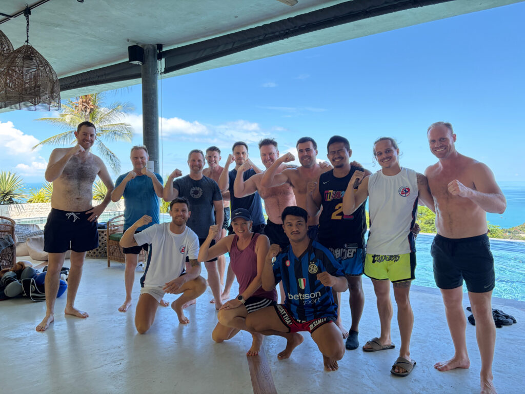 A group posing together at a poolside villa