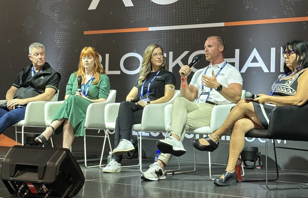 A panel of speakers seated on stage at the Australian Crypto Convention